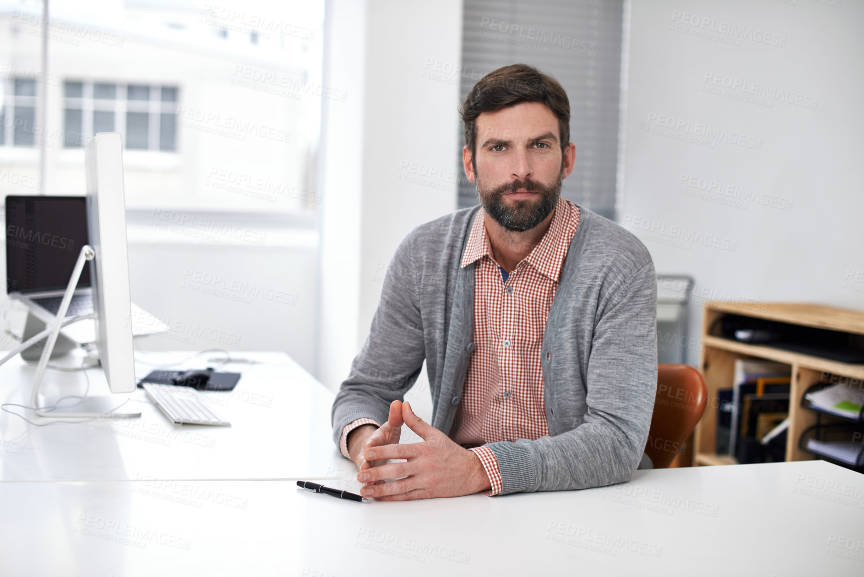 Buy stock photo Businessman, portrait or serious at desk in modern office, professional or career pride in company. Accountant, face or confident as consultant auditing job or ambition for commitment in workplace