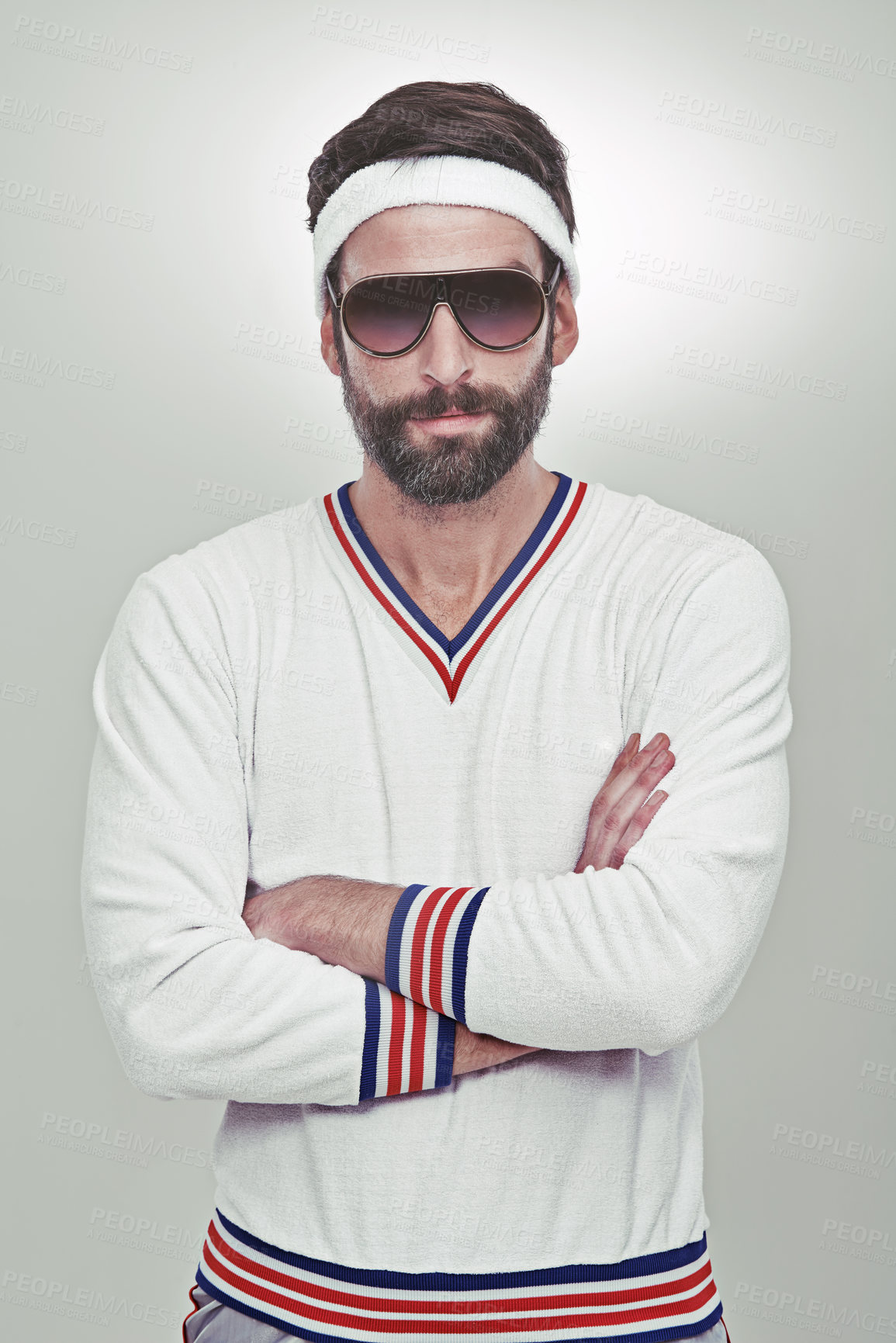 Buy stock photo Portrait of a young man standing with his arms folded in the studio