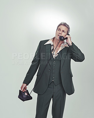 Buy stock photo Senior man, phone call and conversation for discussion in retro or vintage fashion on a gray studio background. Mature, male person talking or listening on telephone for communication on mockup space