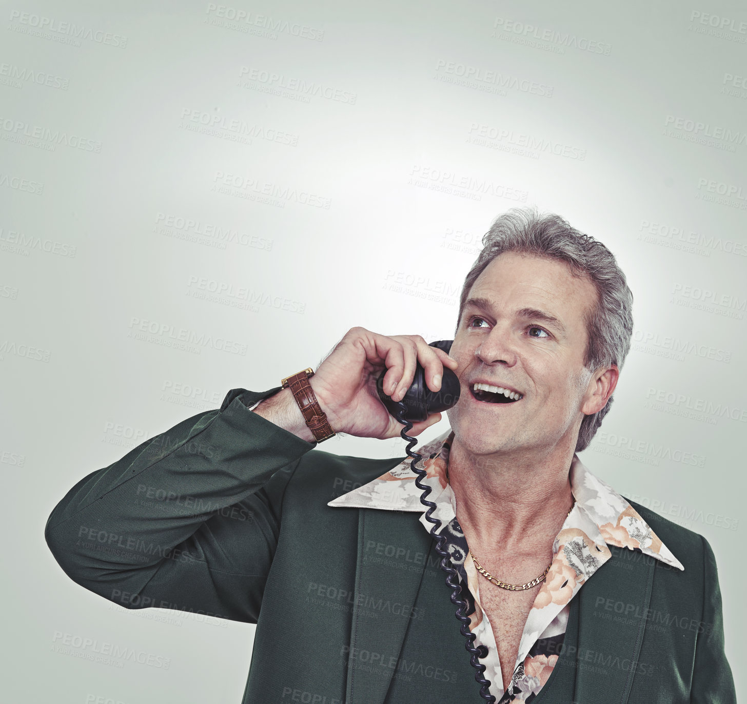 Buy stock photo Cropped studio shot of a mature man in a retro suit talking on an old-fashioned telephone