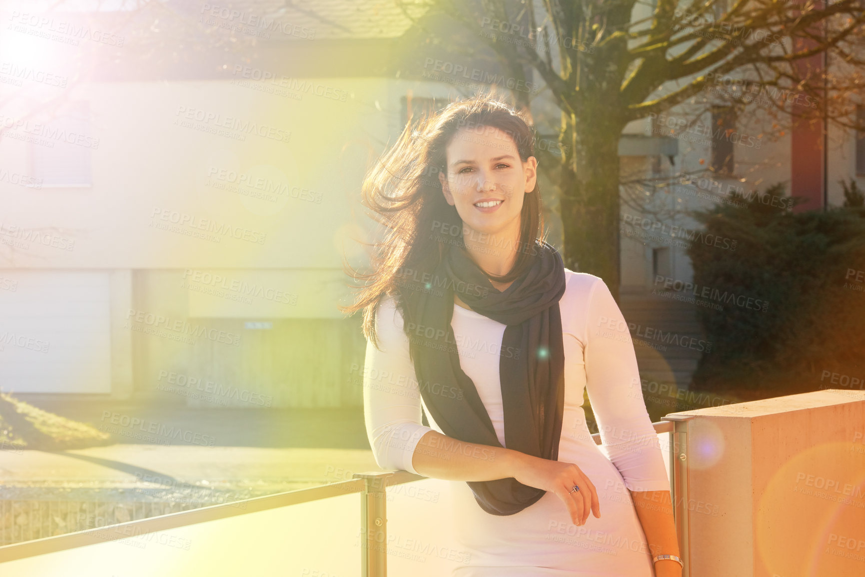 Buy stock photo Portrait, woman and smile in nature for travel, autumn and lens flare with sunshine. Happy, trip and holiday home in Netherlands for vacation and relax or calm, summer or outdoor adventure on balcony