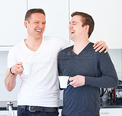 Buy stock photo Laugh, coffee cup and gay couple in home kitchen, love and relax or calm on weekend. Partnership, married people and smile for happy male people, house and morning and conversation with joke or humor