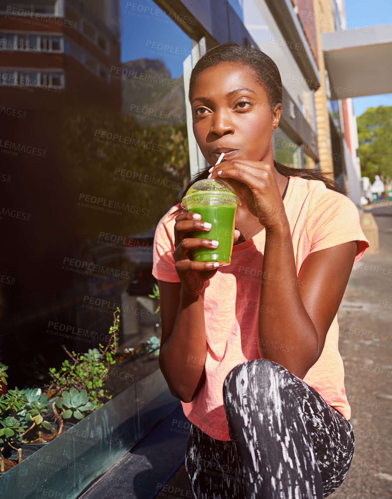 Buy stock photo Black woman, fitness and drinking with smoothie in city for hydration, detox or health and wellness. Young African, female person or organic juice for nutrition, weight loss or vitamins in urban town