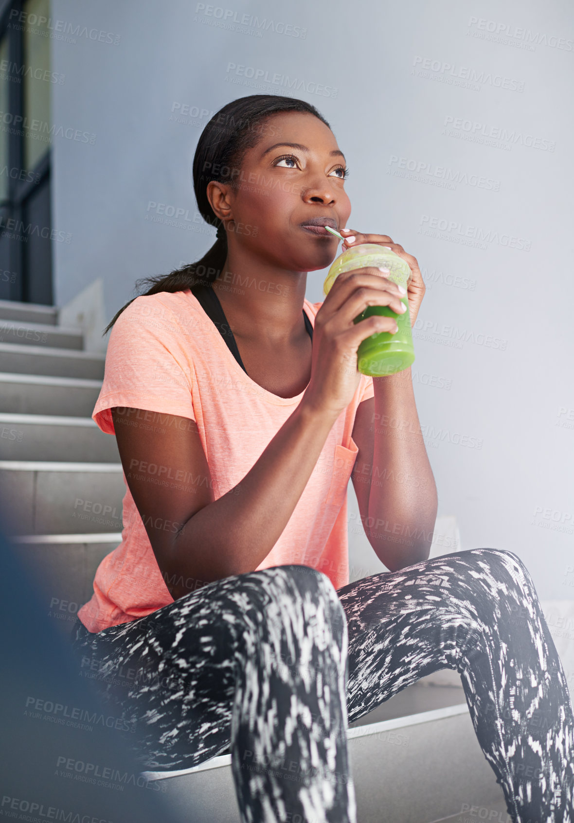 Buy stock photo Happy, black woman or thinking with smoothie for detox, drinking or hydration in health and wellness on staircase. Young African, female person or wonder with green juice for weight loss or diet