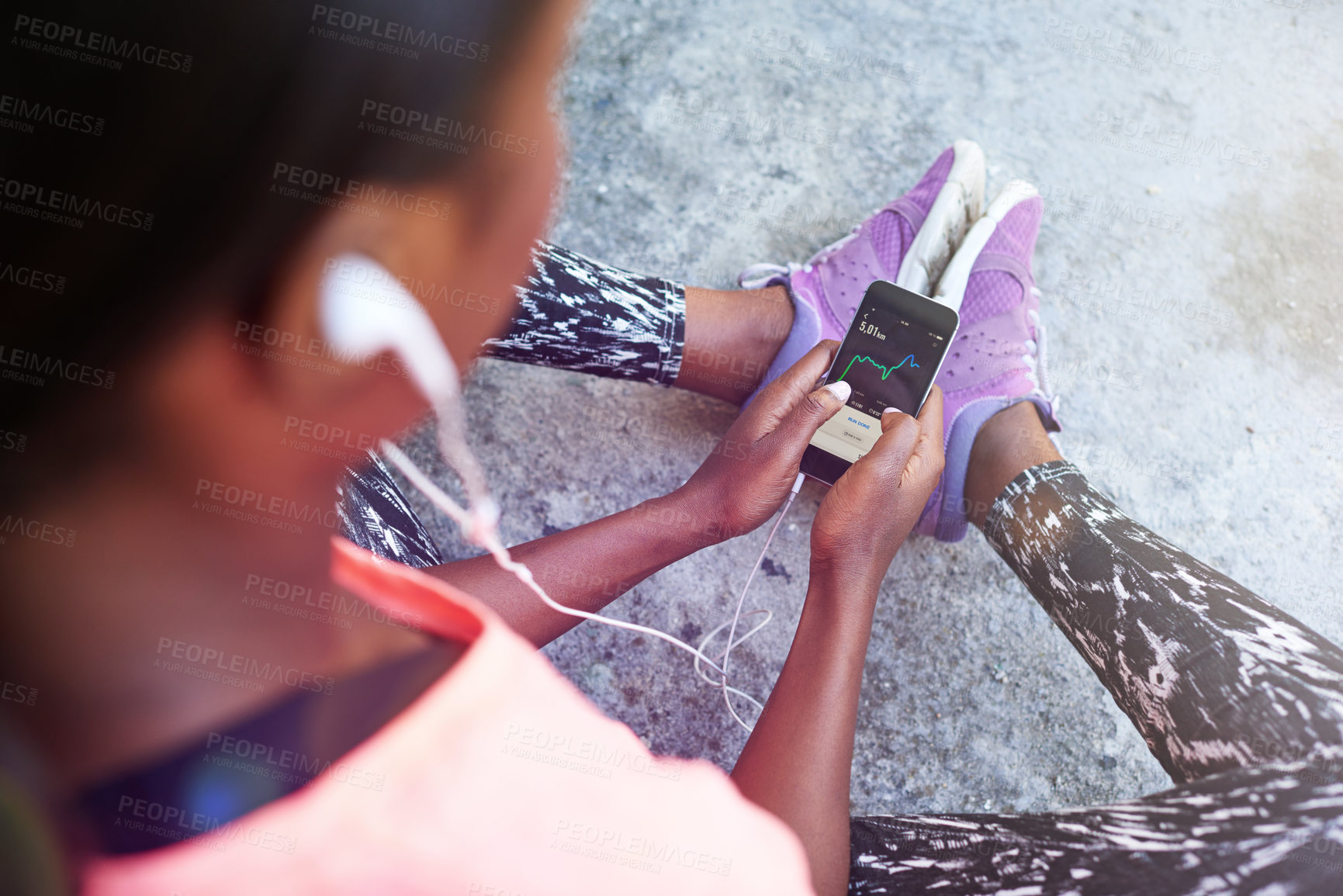 Buy stock photo Woman, hands and phone with earphones above for fitness tracker, radio podcast or music in city. Top view, female person or runner with mobile smartphone for step counter, workout app or audio stream