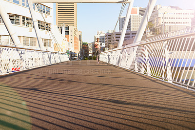 Buy stock photo Black woman, running and fitness with bridge in city for cardio exercise, training or outdoor workout. Young African, female person or active runner with asphalt or path for race, sprint or marathon