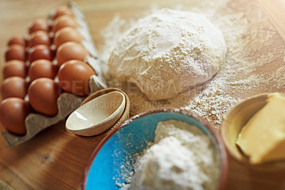 Buy stock photo Above, eggs and flour with dough for ingredients, cooking or bread production in kitchen. Food, butter and nutrition with wood board and baking in home for dessert, culinary and pastry preparation