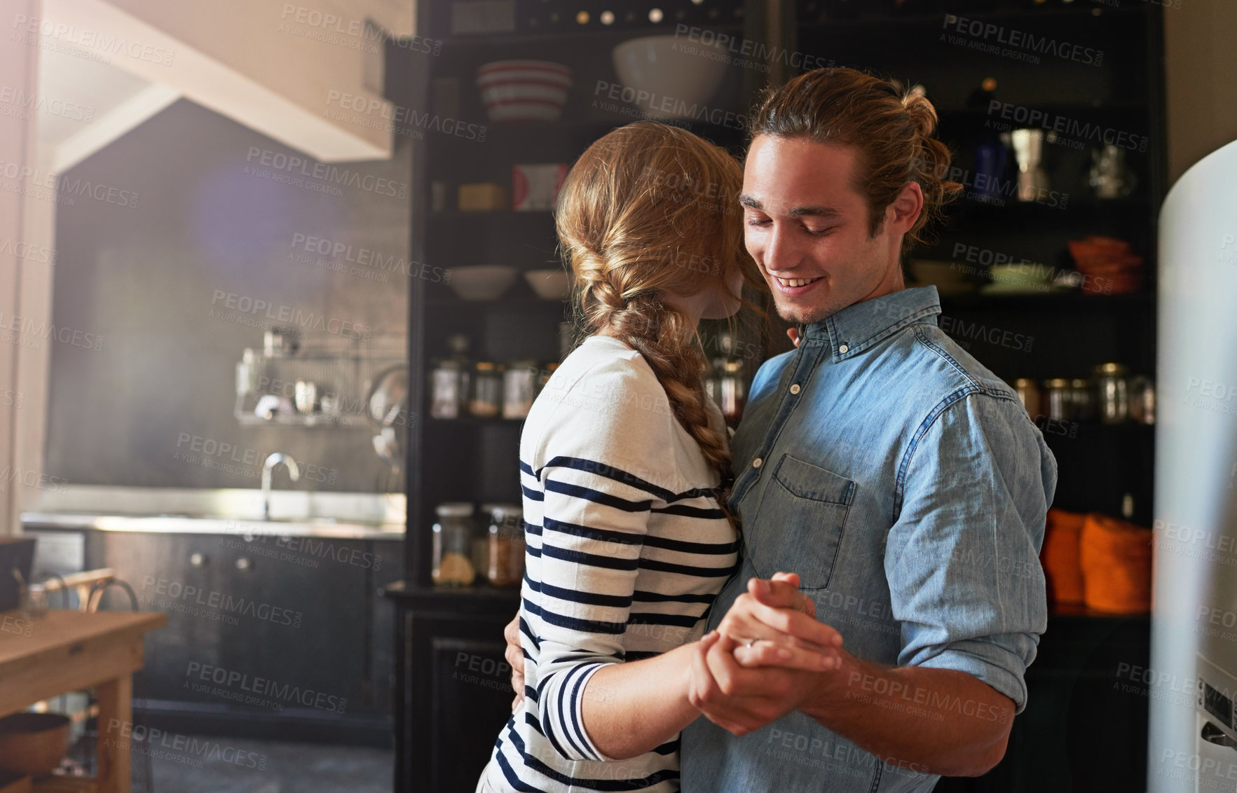 Buy stock photo Holding hands, dance or happy couple with romance in kitchen for food, meal prep or cooking. Smile, hug and people in apartment to celebrate anniversary for love at dinner, lunch or brunch in Spain