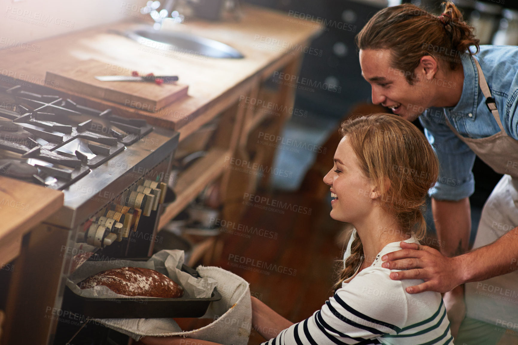 Buy stock photo Happy couple, bread and oven with baker in kitchen for home made wheat, snack or meal together. Man, woman and baking with smile, mini loaf or sourdough for cooking creation, breakfast or morning