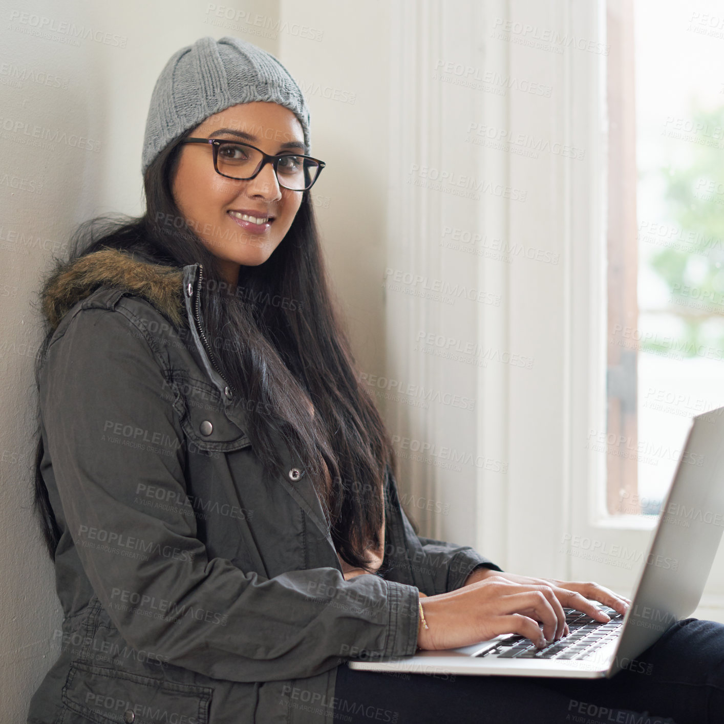 Buy stock photo A young woman using her laptop at home