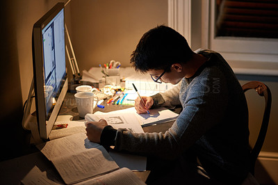 Buy stock photo Cropped shot of a young student studying late into the night