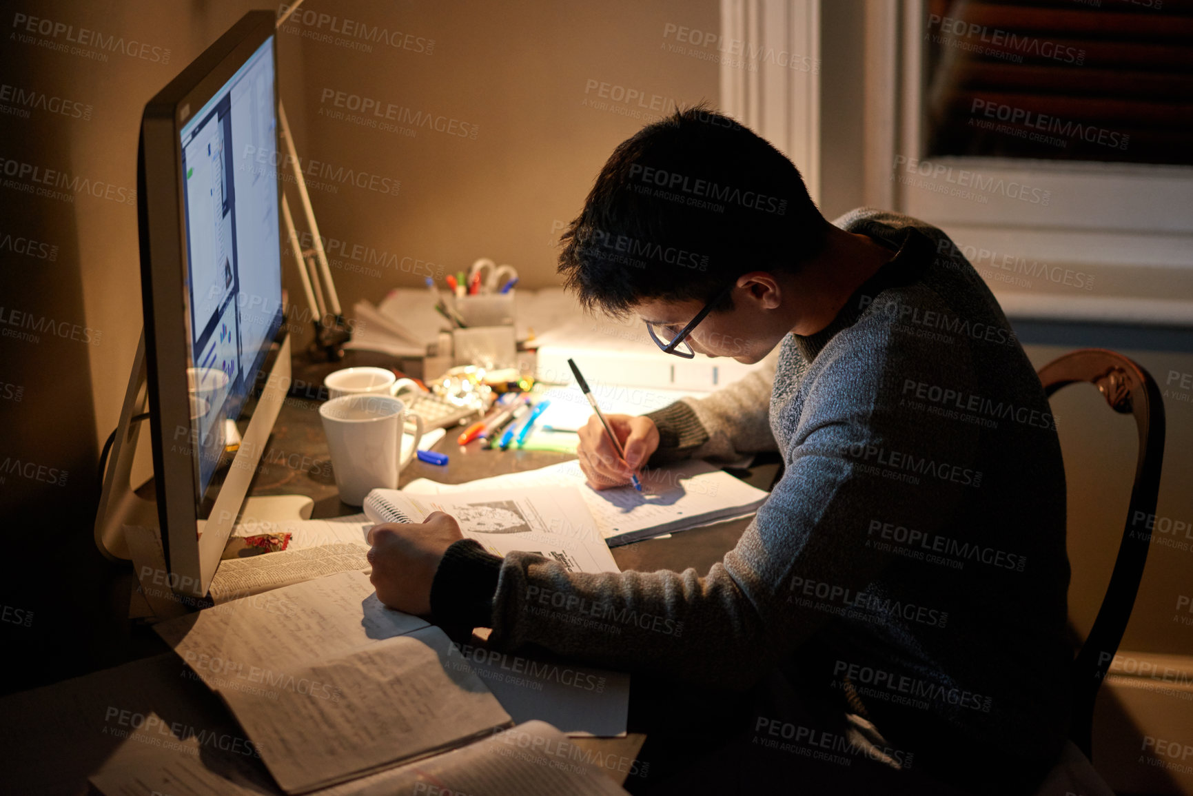 Buy stock photo Cropped shot of a young student studying late into the night