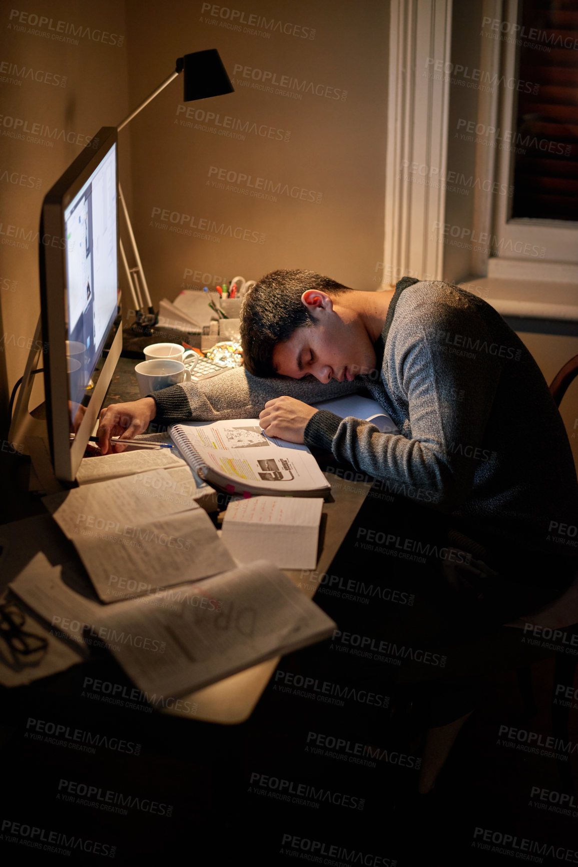 Buy stock photo Student, books and sleep or studying late into the night on screen or sleeping on table and reading for examination.Tired, research and male scholar on computer or test paper fatigue at home