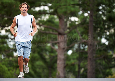 Buy stock photo Exercise, man and running on road for fitness, earphones and listening to music, podcast and audio. Male athlete, workout and training for wellness, performance and endurance challenge on street