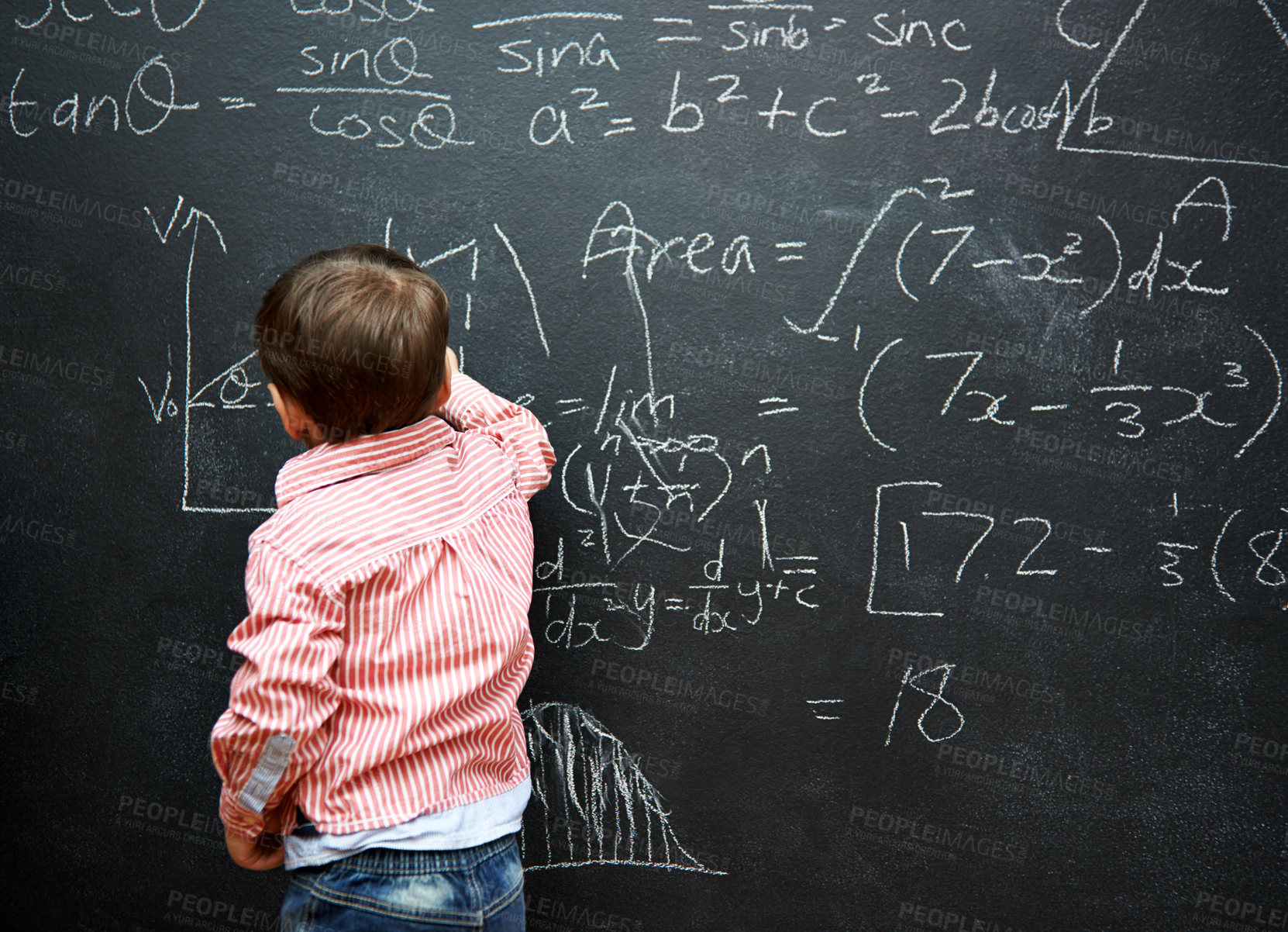 Buy stock photo Shot of a young boy with a blackboard full of math equations