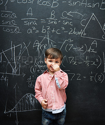 Buy stock photo Child, boy and portrait with smile by blackboard with equations, numbers and education in classroom at school. Kid, student and happy for knowledge, learning and chalkboard with math and preschool