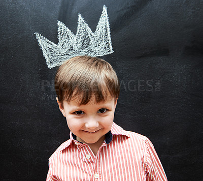 Buy stock photo Little child, portrait and crown on blackboard from mischief of drawing by cute boy in classroom. Young kid, creative and artistic in preschool for elementary education, youth and clever student