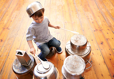 Buy stock photo Shot of an adorable little boy drumming on pots and pans