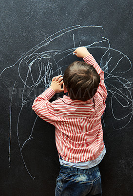 Buy stock photo Young child, scribble and art on chalkboard in classroom of preschool for education of little boy. Kid, drawing and creative on blackboard with illustration for elementary, student and sketch
