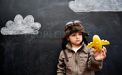 Buy stock photo Kids, chalkboard and toy plane with boy in studio on black background for fantasy game. Education, imagine and class pilot in costume playing at school for growth, learning or child development