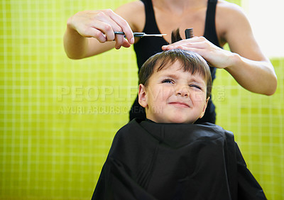 Buy stock photo Child, boy and barber with haircut at salon for grooming, hairstyle and unhappy with scissors. Hairdresser, person and kid for hair treatment, haircare and hairdressing with comb or sitting on mockup