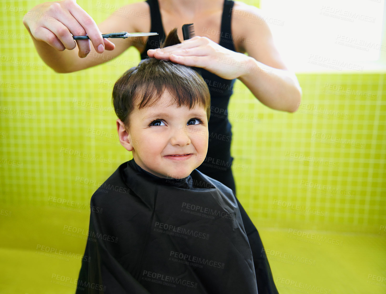 Buy stock photo Child, boy and hairdresser with haircut at salon for grooming, hairstyle and grimace with scissors and comb. Barber, person and kid for hair treatment, haircare and hairstyling with cutting and happy