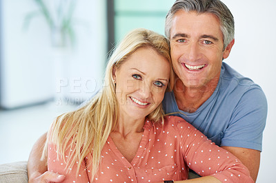 Buy stock photo Portrait of a loving mature couple relaxing at home