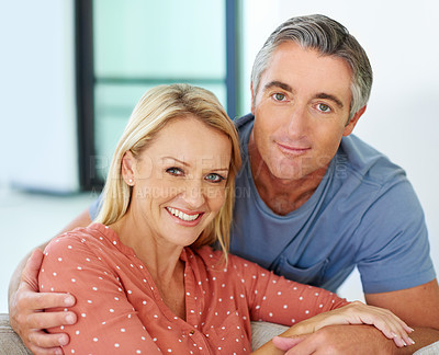 Buy stock photo Portrait of a loving mature couple relaxing at home