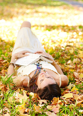 Buy stock photo Shot of an attractive young woman in the park on an autumn day