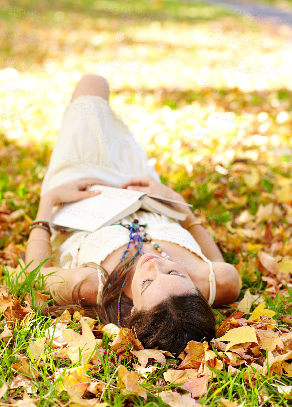 Buy stock photo Shot of an attractive young woman in the park on an autumn day