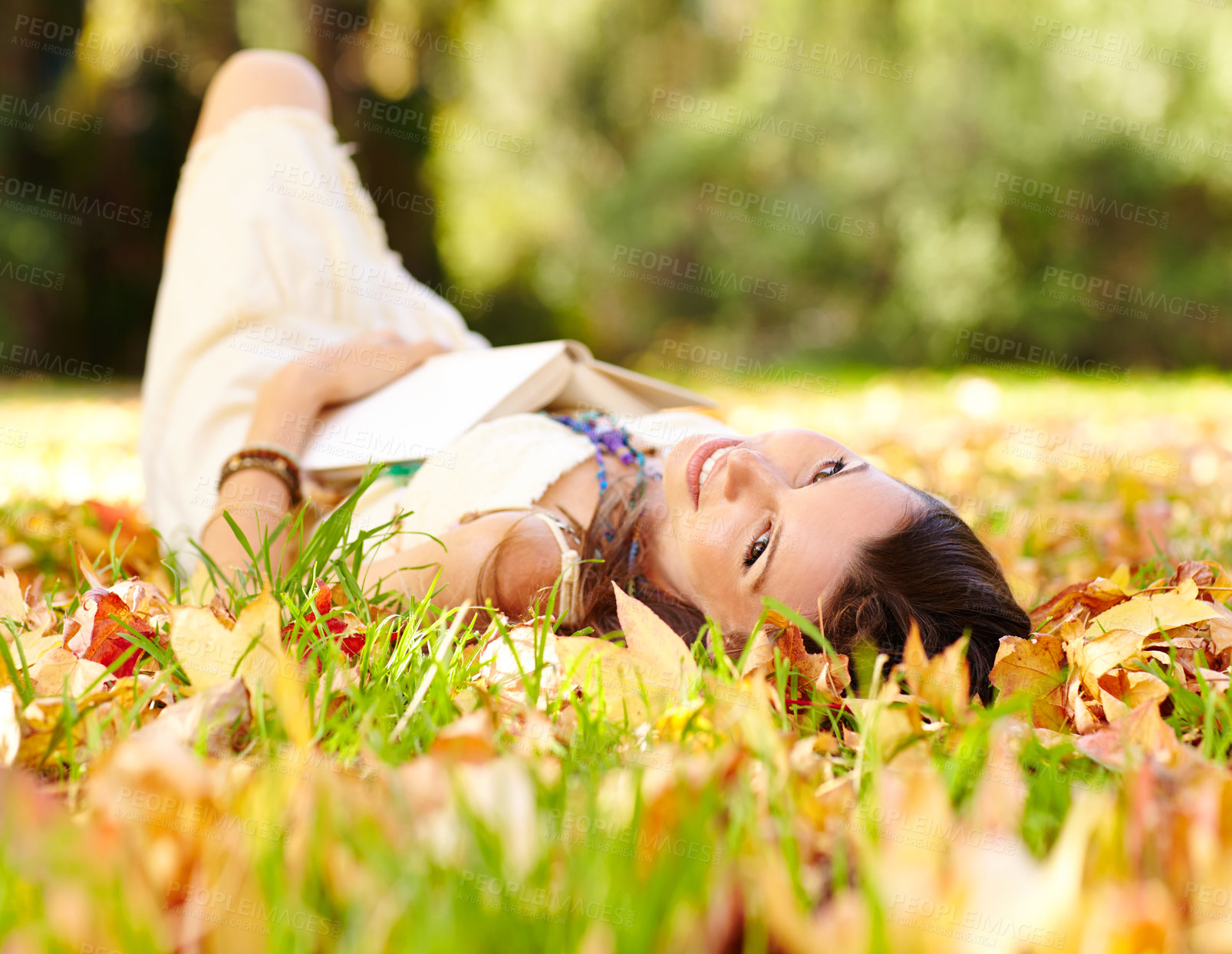 Buy stock photo Portrait, book and woman relax in park with novel in nature learning for education as student outdoor on campus. University, portrait and young person with textbook on grass field for scholarship