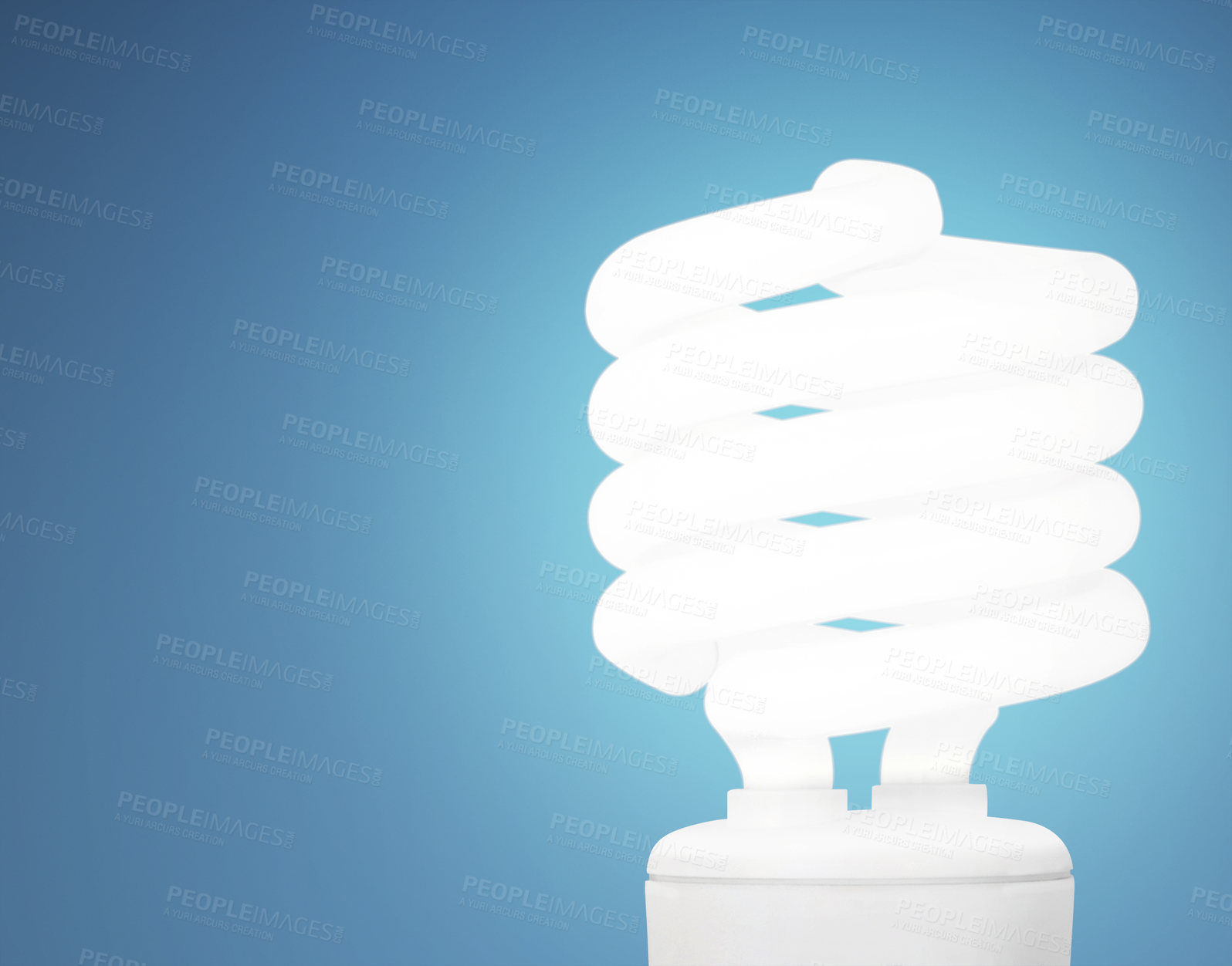 Buy stock photo Studio shot of an energy saving lightbulb against a blue background