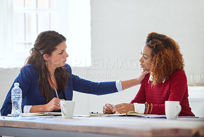 Buy stock photo Shot of two colleagues having a discussion in an office
