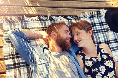 Buy stock photo Picnic, couple and smile with lying on ground on break with love, rest and affection for care. Outdoor, people and happy in relationship on blanket on valentines day for holiday to relax and bonding