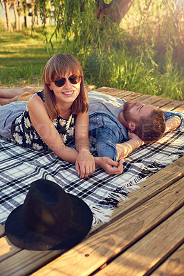 Buy stock photo Blanket, picnic and smile with couple outdoor on deck in nature together for date, love or romance. Anniversary, green or nature with happy man and woman on wooden pier to relax for valentines day