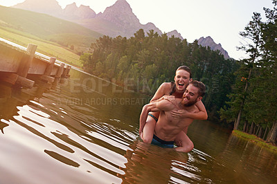 Buy stock photo Happy, piggyback or portrait of couple at lake together on vacation, romantic anniversary or holiday. Relationship, swimming and people in water for bonding, love or trust on honeymoon for travel