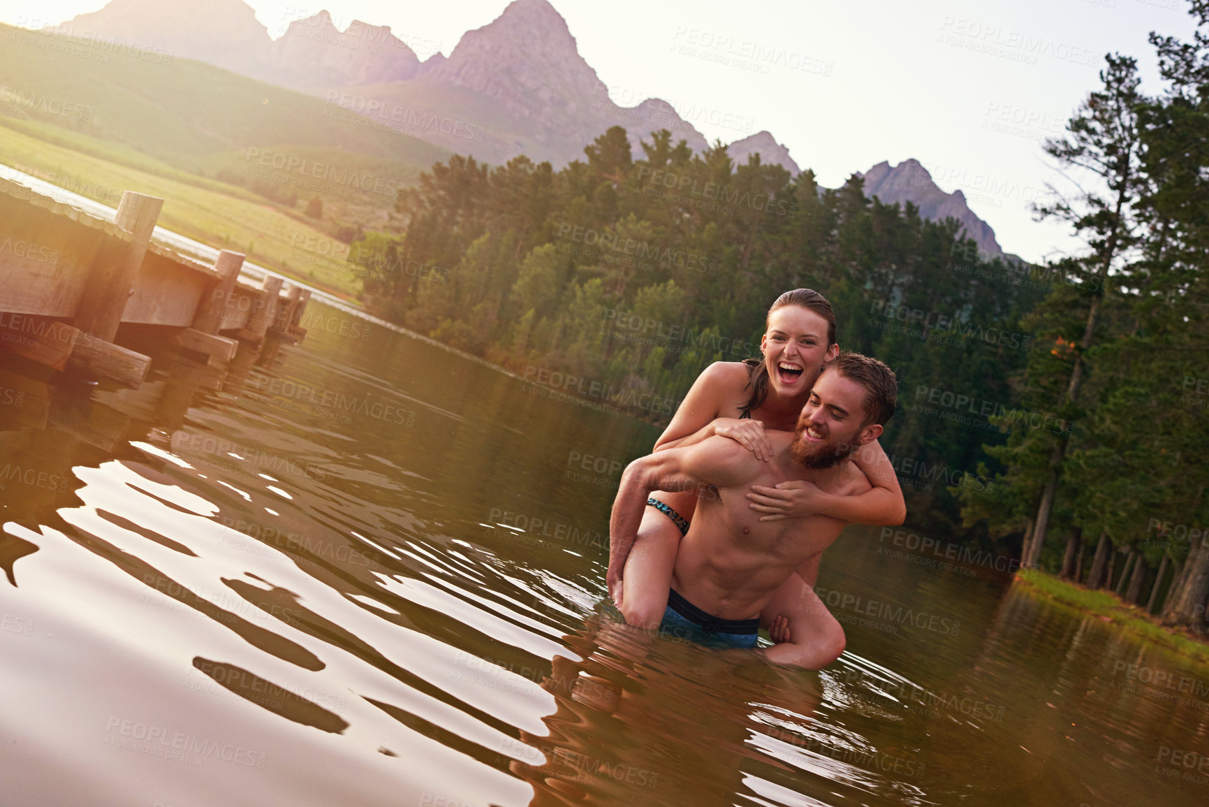 Buy stock photo Happy, piggyback or portrait of couple at lake together on vacation, romantic anniversary or holiday. Relationship, swimming and people in water for bonding, love or trust on honeymoon for travel