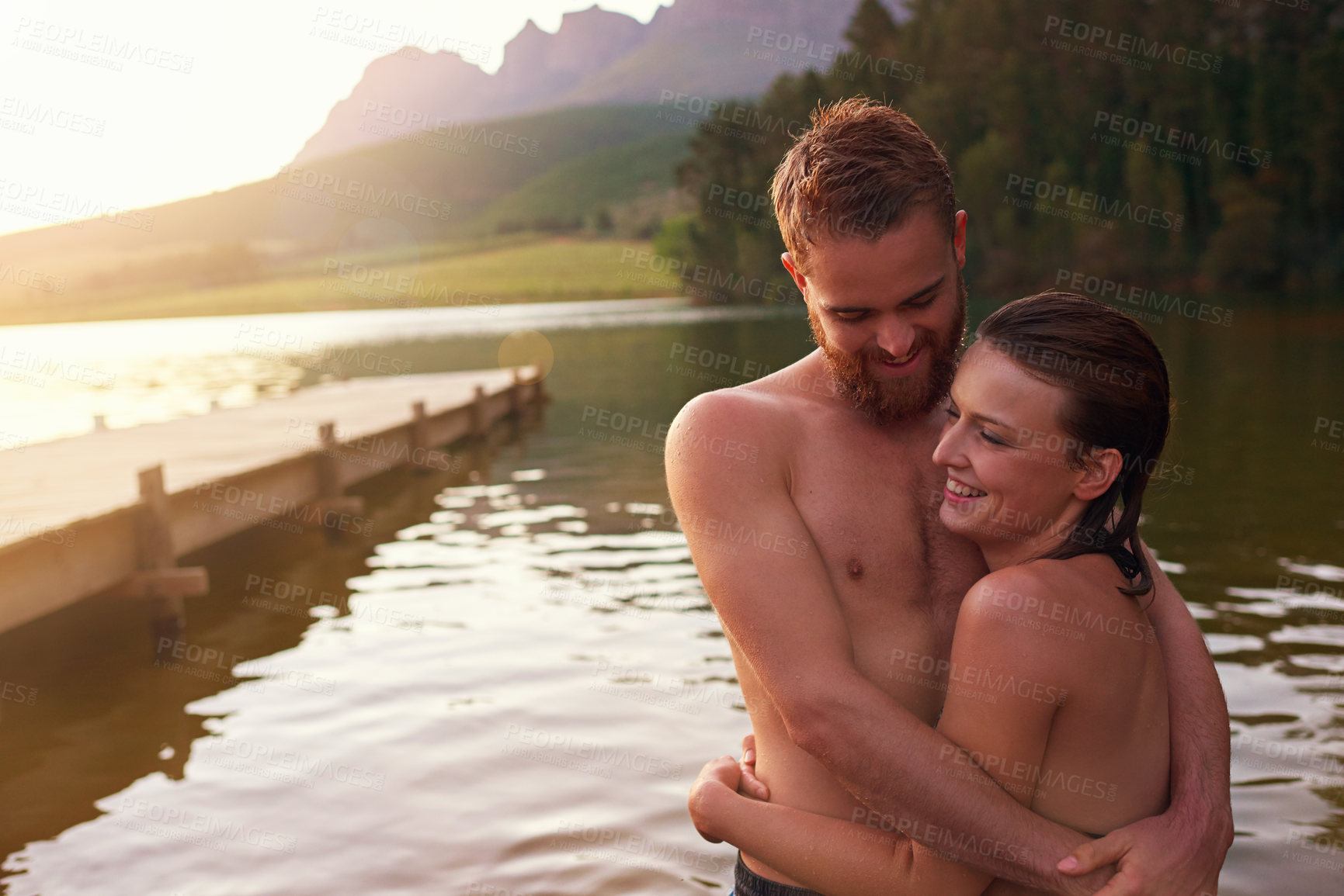 Buy stock photo Couple, hug and swimming in lake on holiday with affection, relationship and happy for summer adventure. People, embrace and smile in river at countryside for romantic vacation and bonding together