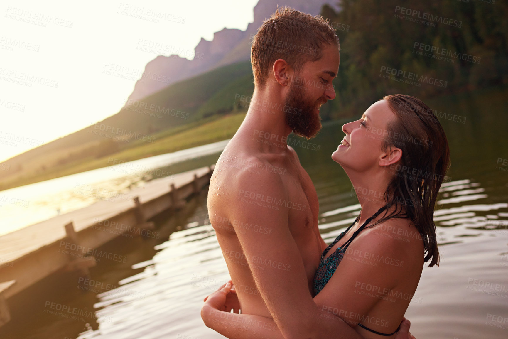 Buy stock photo Couple, hug and swimming in lake on vacation with affection, relationship and happy for summer adventure. People, embrace and smile in river at countryside for romantic holiday and bonding together