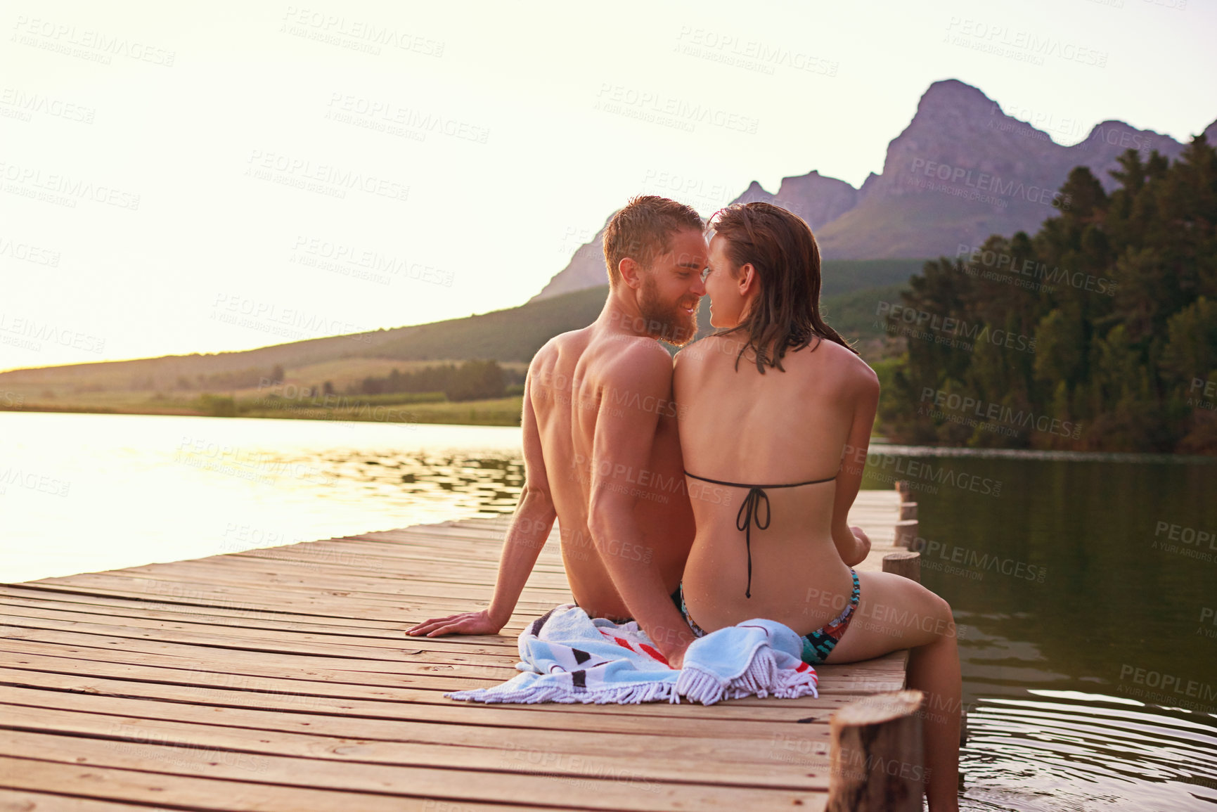 Buy stock photo Travel, romantic or couple on dock at lake together on vacation, anniversary or outdoor holiday. Relationship, support or people by water for bonding, trust or love on honeymoon date to relax on trip