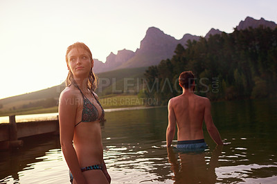 Buy stock photo Shot of an affectionate young couple at the lake