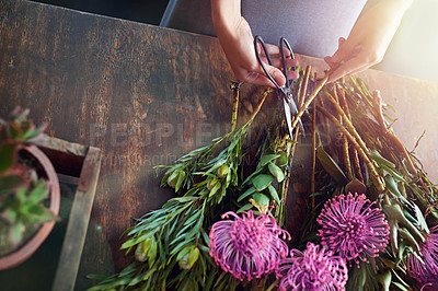 Buy stock photo Cropped shot of a pretty floral bouquet being completed on a wooden counter top
