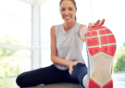 Buy stock photo Portrait of an attractive young woman stretching before a workout