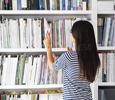 Buy stock photo Student, woman and back by bookshelf with search, studying and development at university for knowledge. Person, girl and research in library with books, check and inspection for learning at college