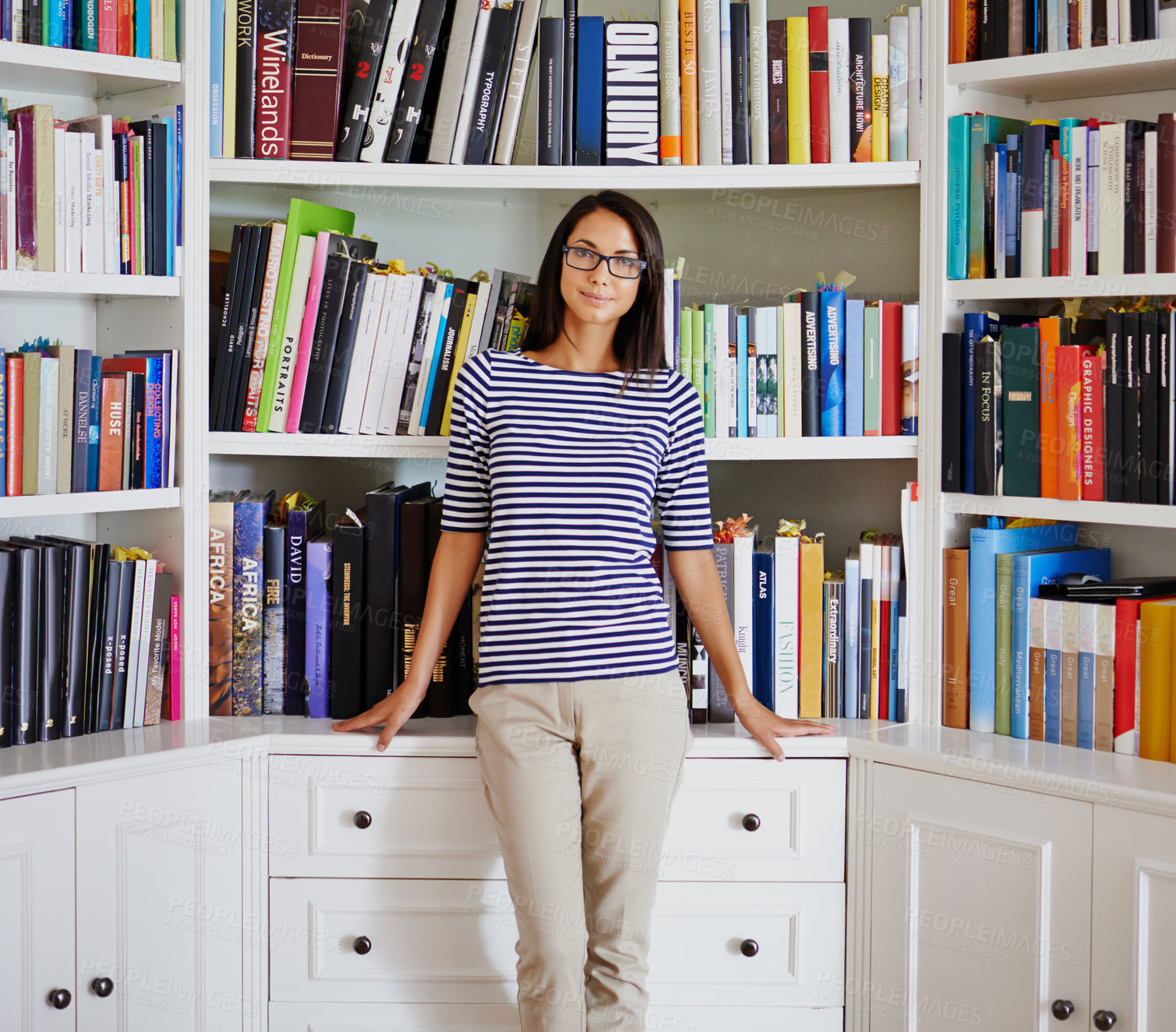 Buy stock photo Woman, portrait and smile by bookshelf in house with books for reading, learning and knowledge in living room. Professor, face and happy by home library with magazine, journal and study collection