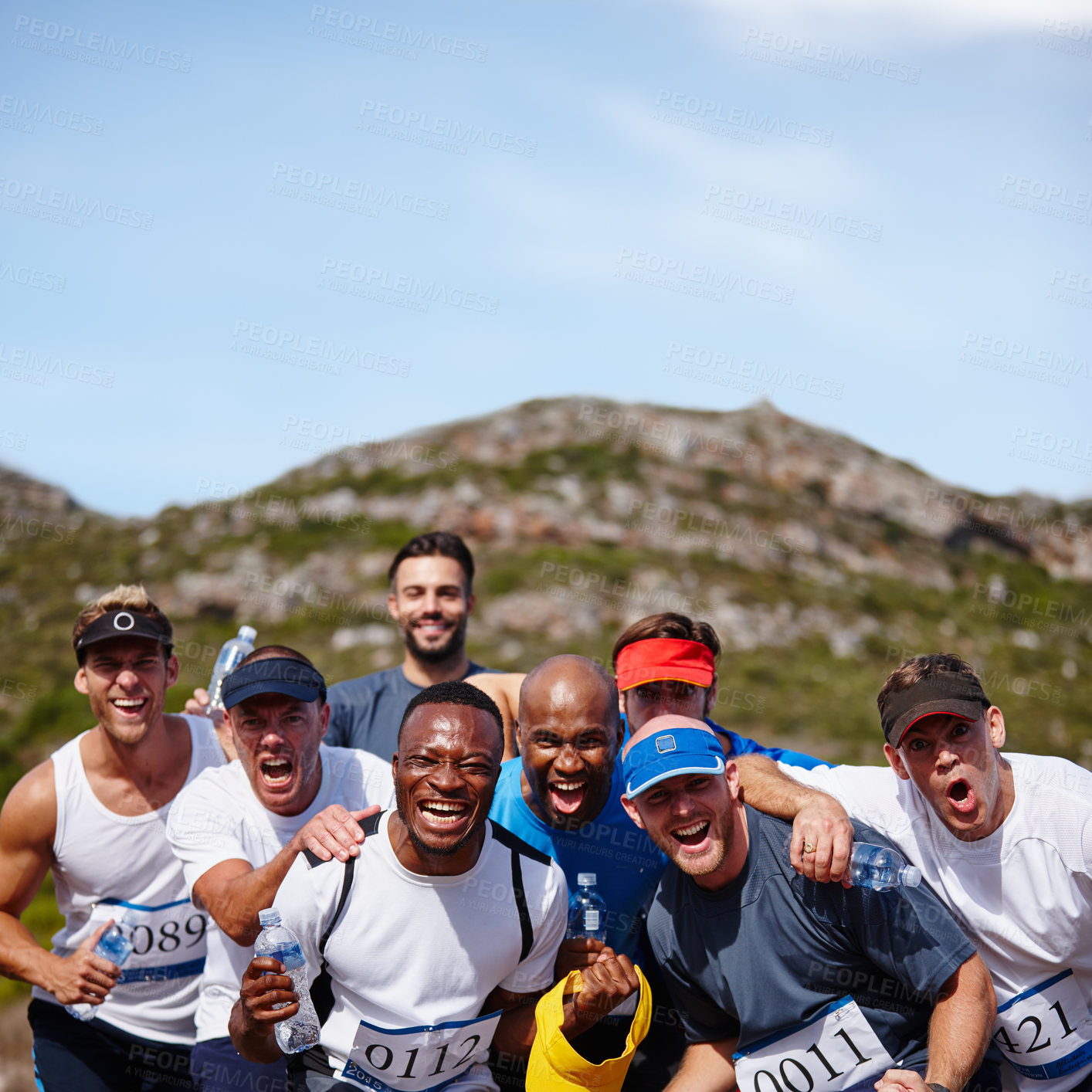Buy stock photo Shot of a group of young men looking excited before a marathon