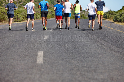 Buy stock photo Rearview shot of a group of male runners during a marathon