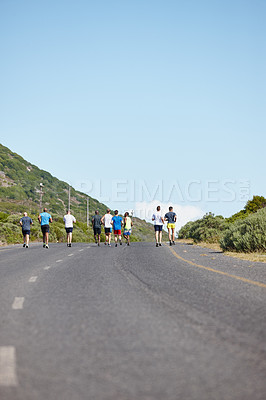 Buy stock photo Rearview shot of a group of men running a marathon