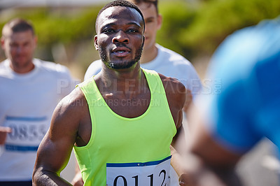 Buy stock photo Shot of a young man running in a marathon