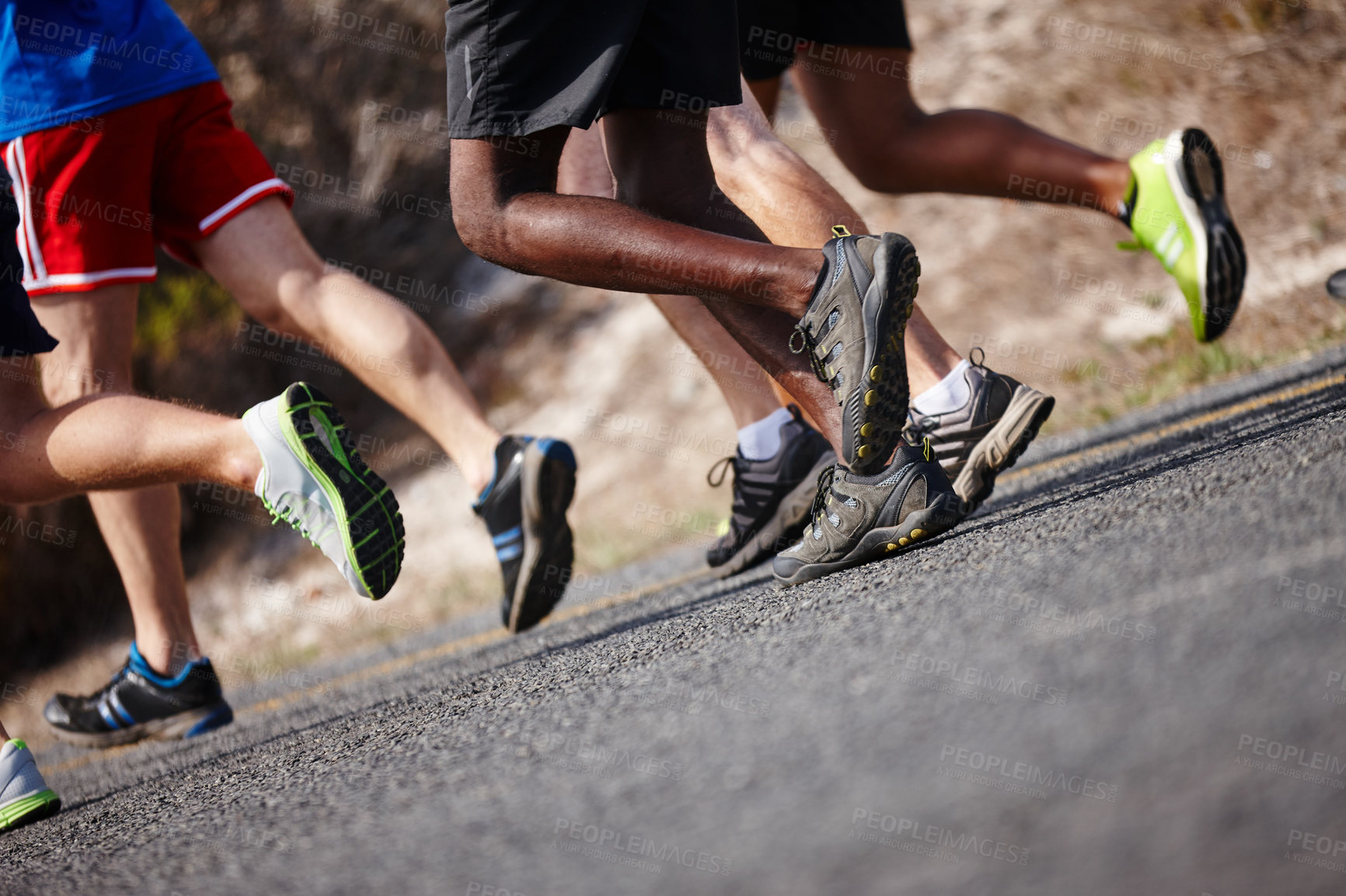 Buy stock photo Shot of the legs of a group of men running a road race